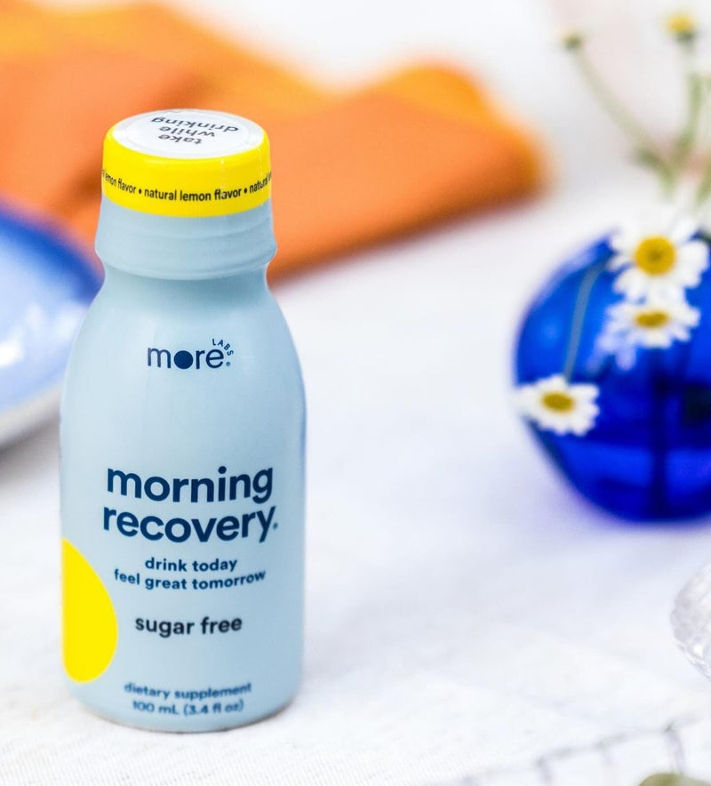 A ready-to-drink bottle of More Labs Morning Recovery dietary supplement, sugar-free, on a tabletop.