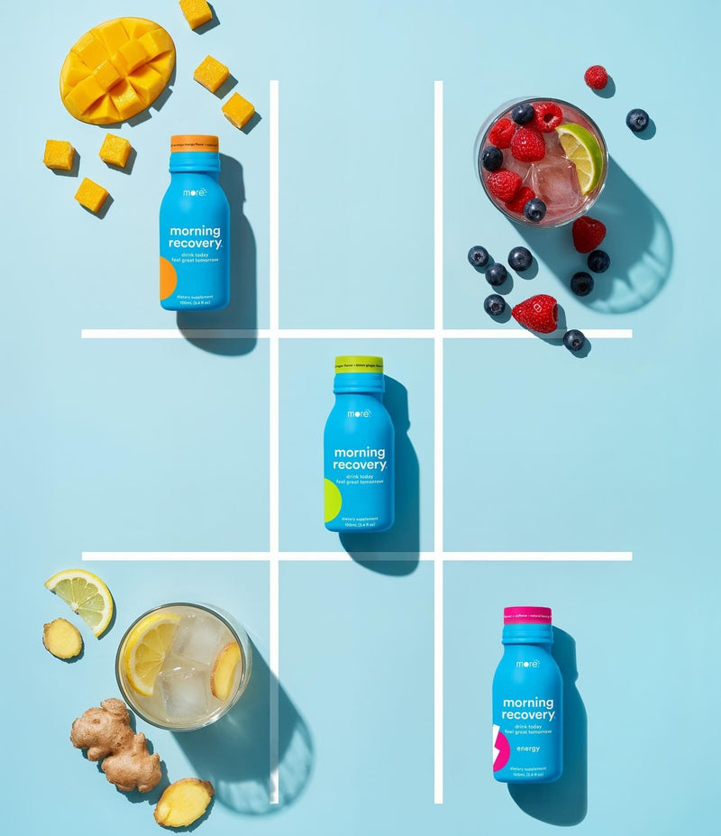  Three Morning Recovery bottles in a winning tic-tac-toe formation with fresh fruit and cocktails.
