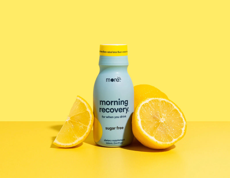 More Labs Morning Recovery dietary supplement with natural lemon flavor, surrounded by lemon halves.