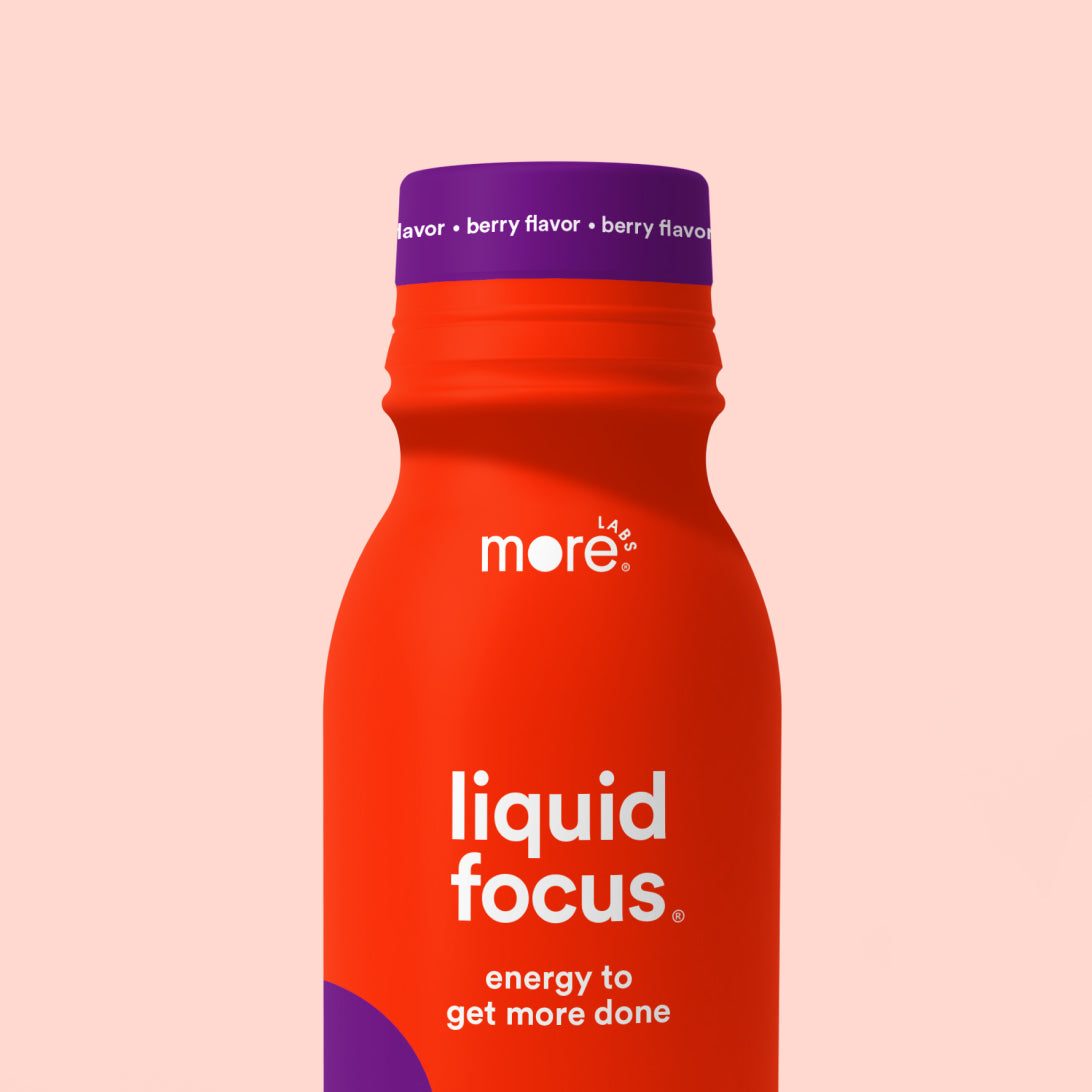 More Labs Liquid Focus energy drink bottle with berry flavor on a soft pink background.
