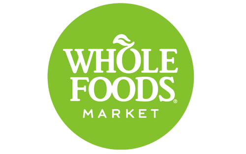 Whole Foods Market logo in white text inside a green circular design on a transparent background.

