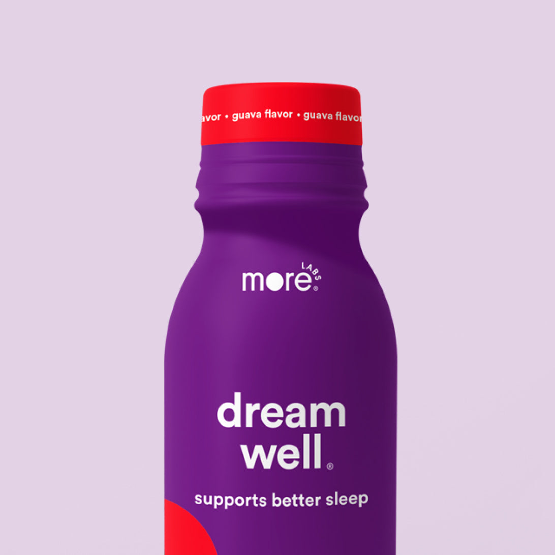 More Labs Dream Well sleep support drink bottle with guava flavor on a light purple background.
